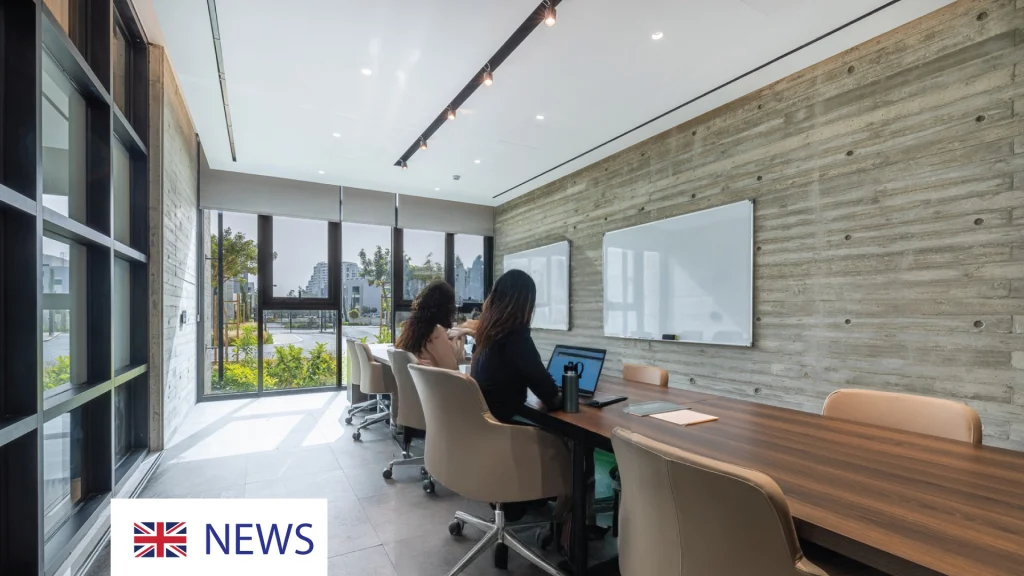 Modern meeting room with large windows and a long wooden table.