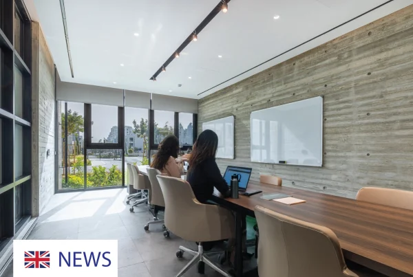 Modern meeting room with large windows and a long wooden table.