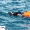 man swimming in the sea